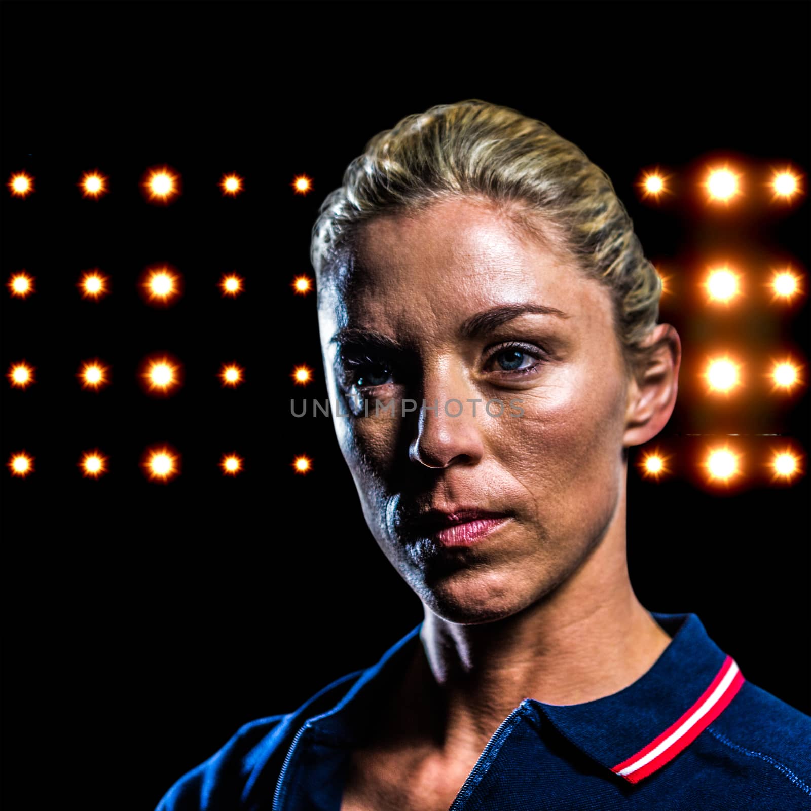 Close-up of female tennis player against composite image of orange spotlight 