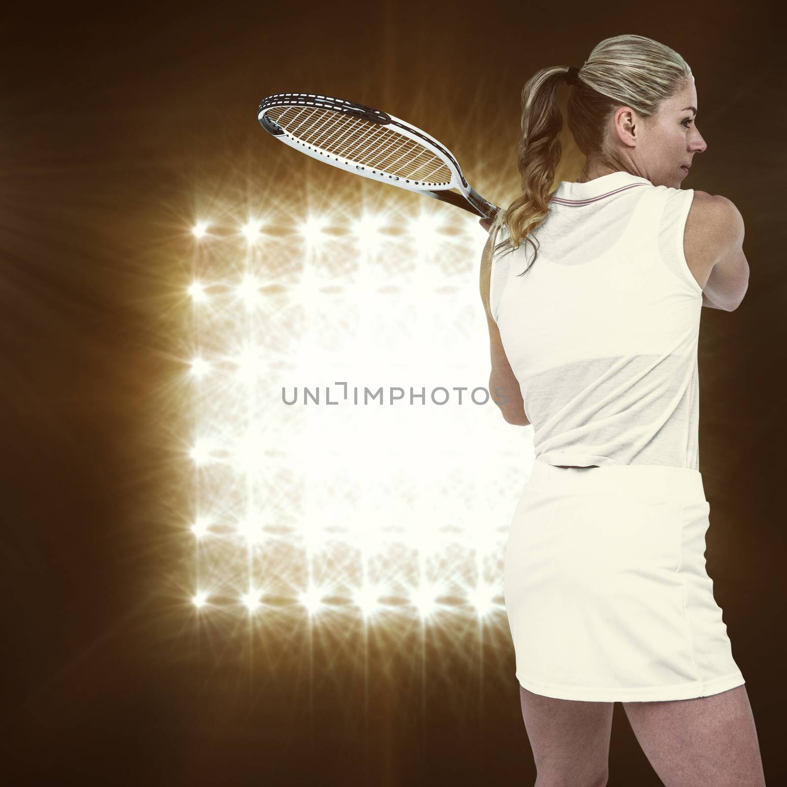 Athlete playing tennis with a racket  against spotlight