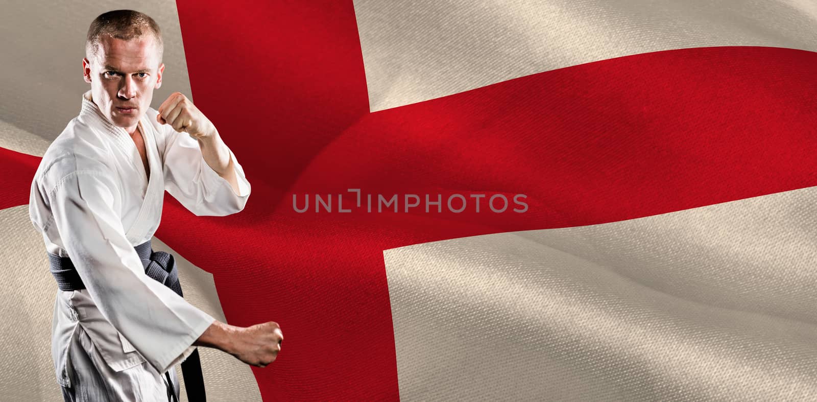 Fighter performing karate stance against digitally generated england national flag