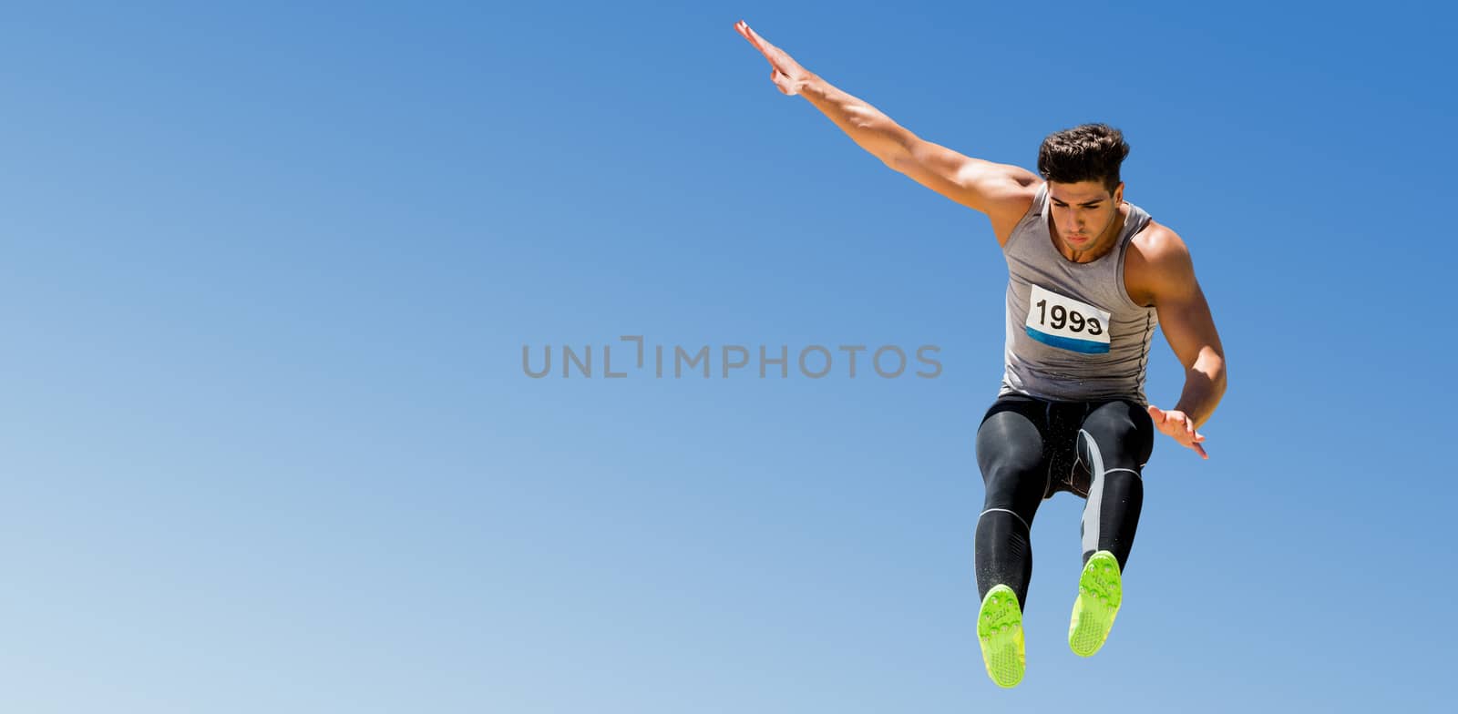 Sportsman jumping on a white background against scenic view of blue sky