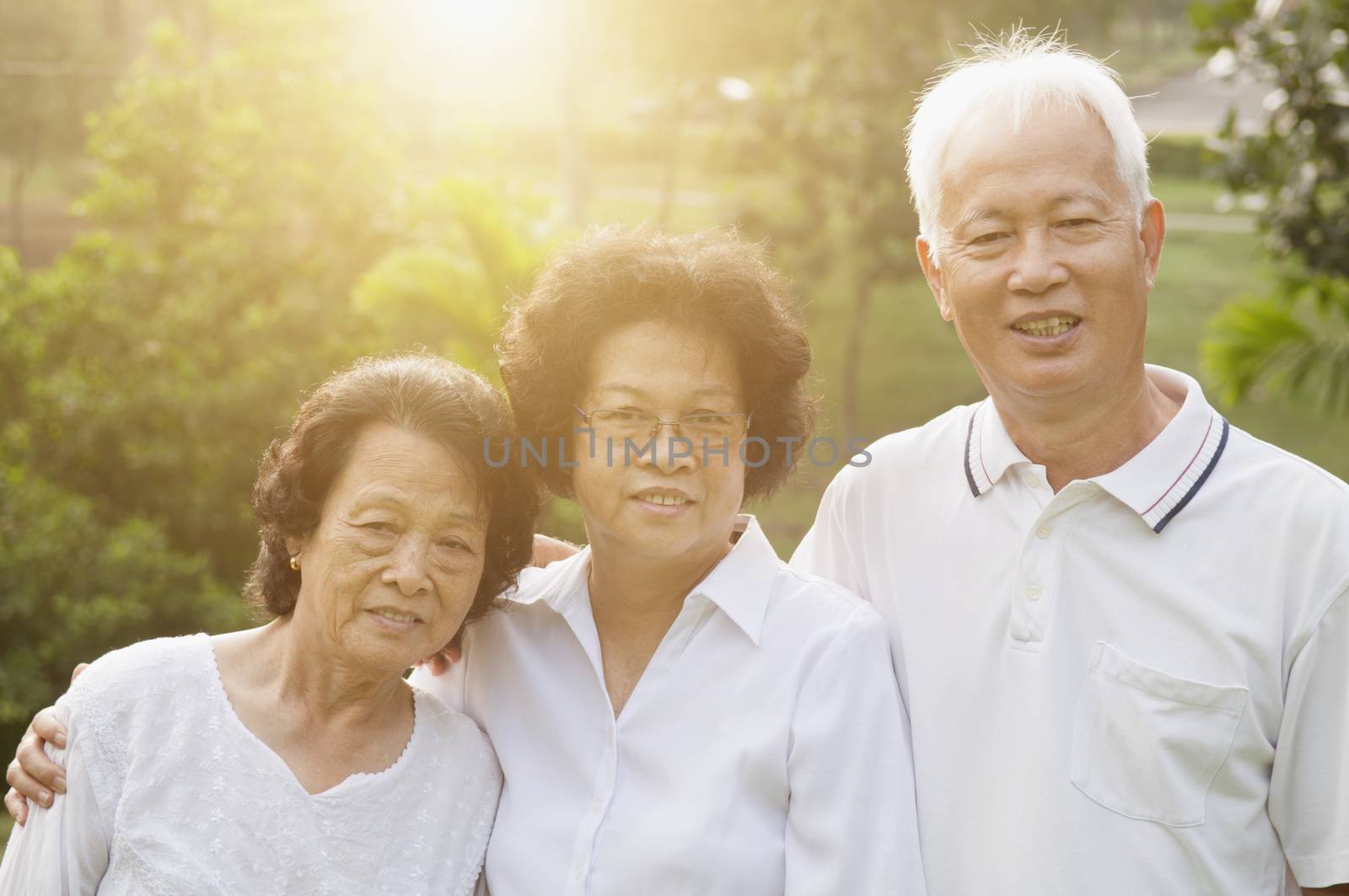 Portrait group of healthy Asian seniors having activities at outdoor nature park, in morning beautiful sunlight at background.