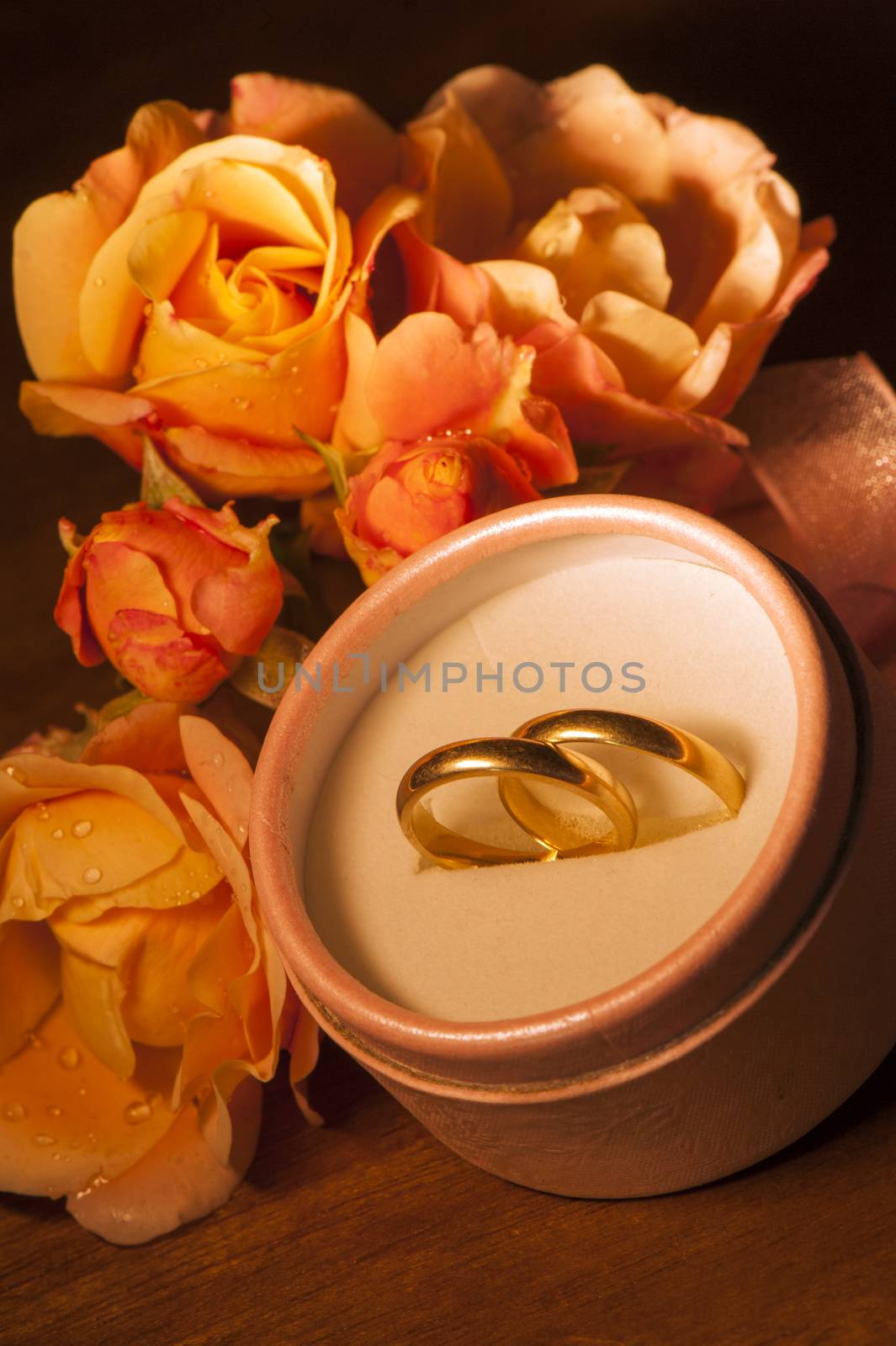  wedding rings on  on a small wooden table