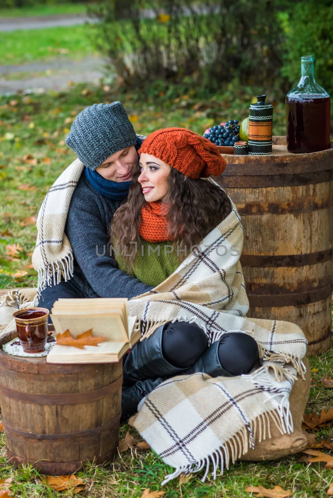 loving couple sitting in the autumn garden