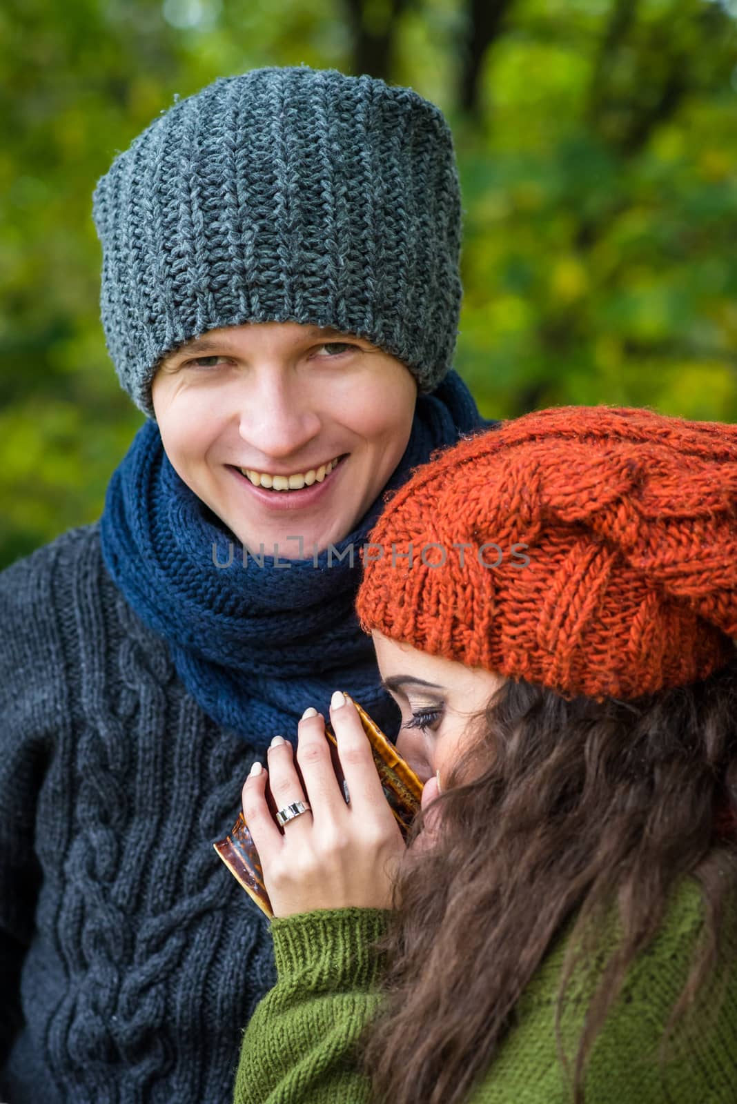 couple in love drinks coffee in the autumn garden