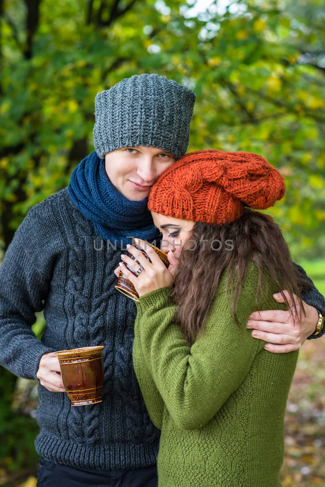 couple in love drinks coffee in the autumn garden