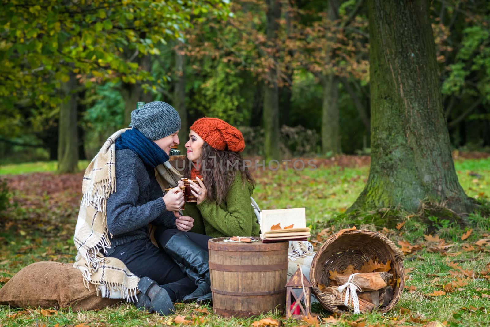 loving couple sitting in the autumn garden