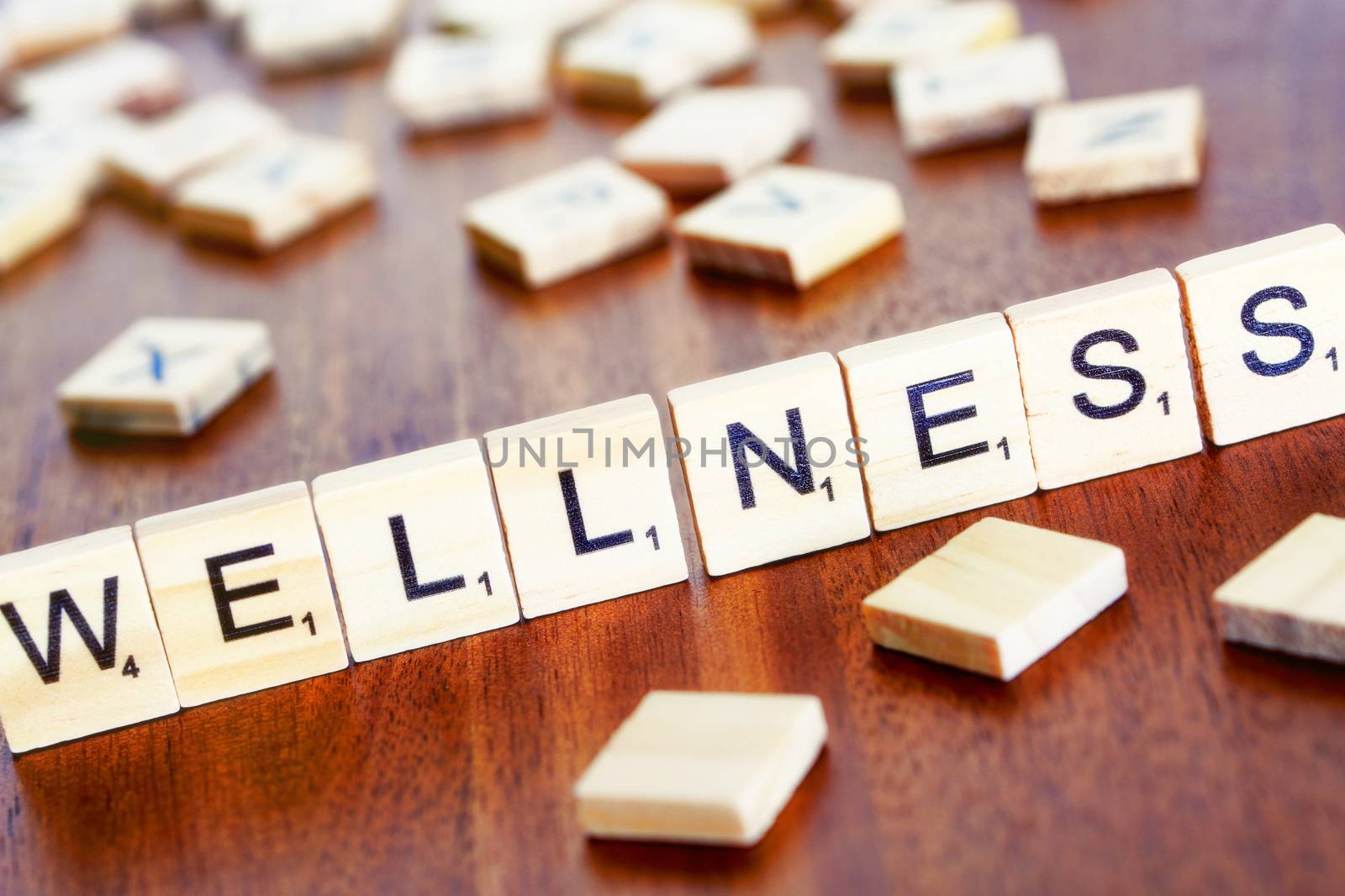 wellness word on block concept, letters placed on a desk in prec by pixinoo