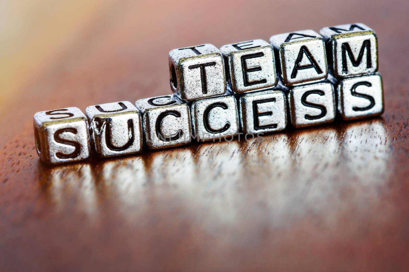 team success business letters on arrange small metal pieces