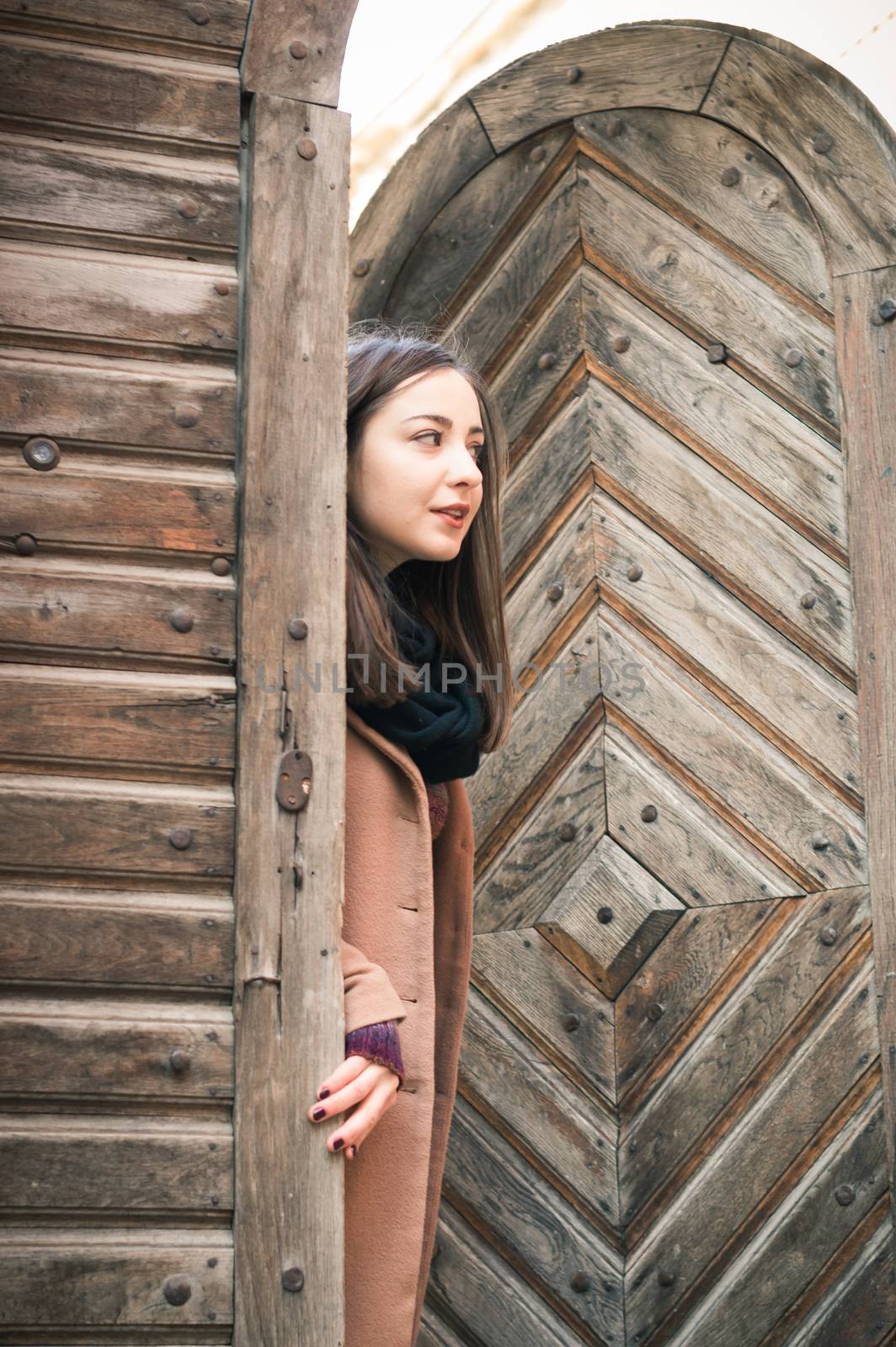 girl near old wooden gate by okskukuruza