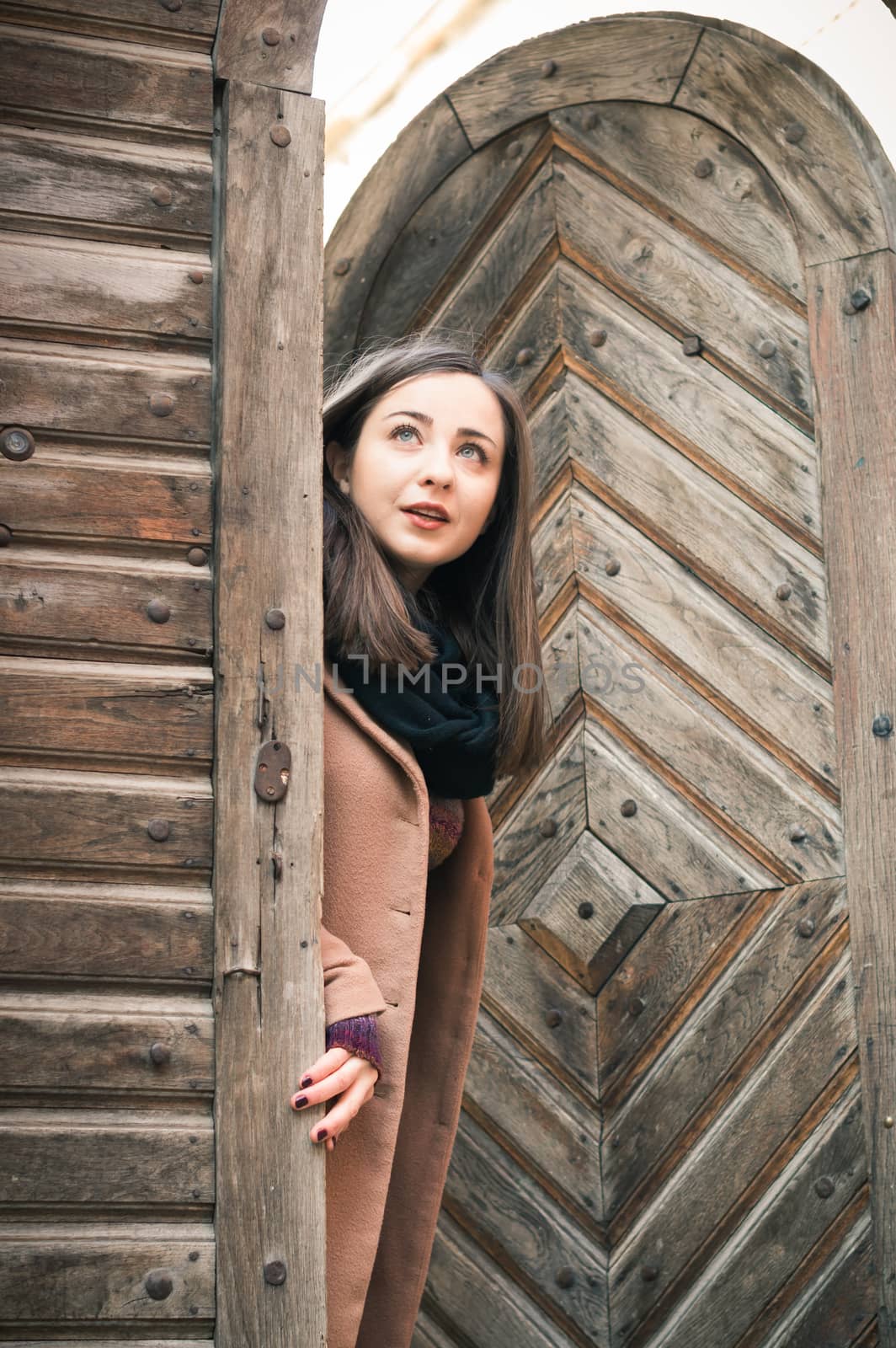 girl near old wooden gate by okskukuruza