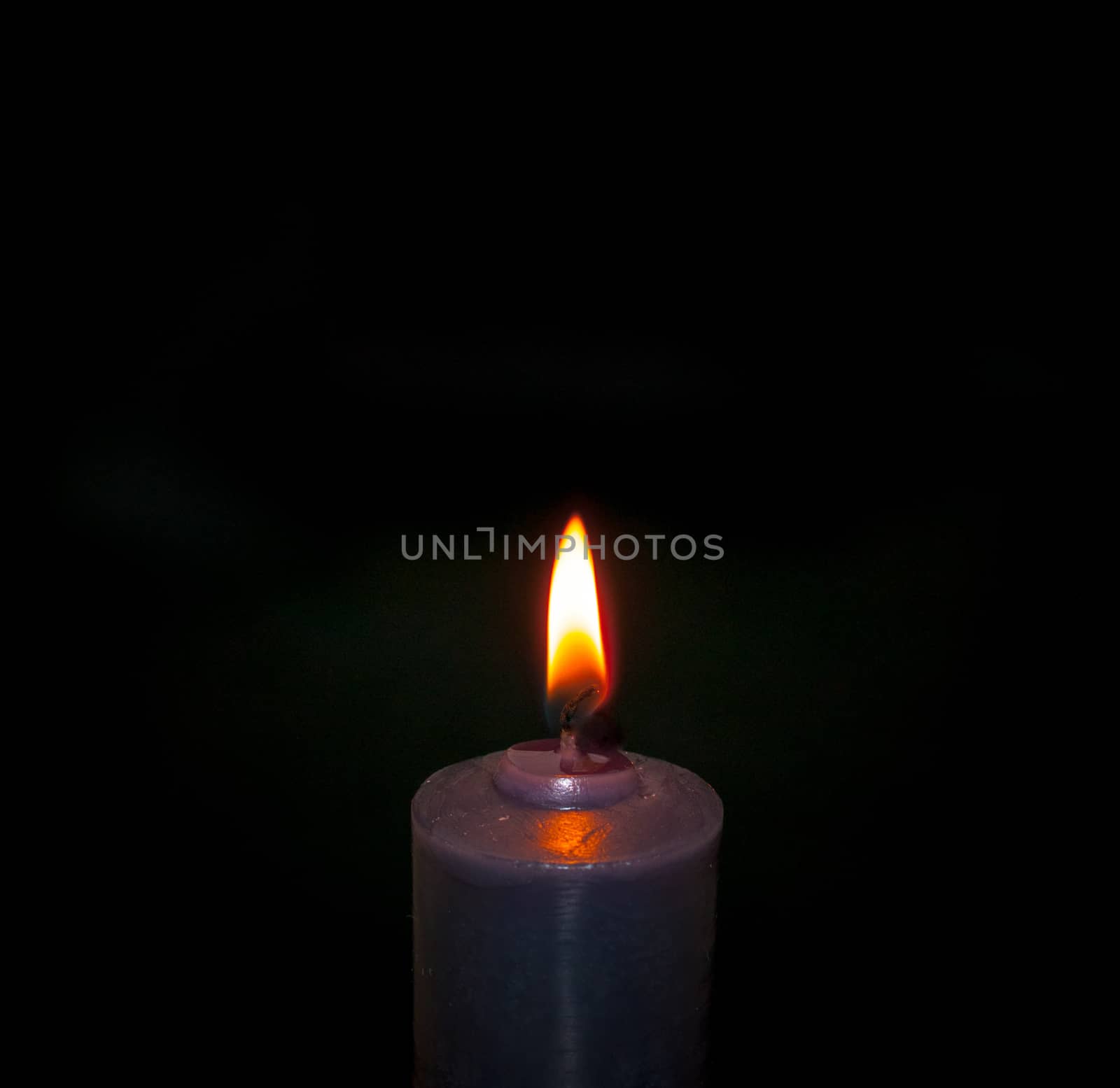 single candle, dark background, close up on the flame