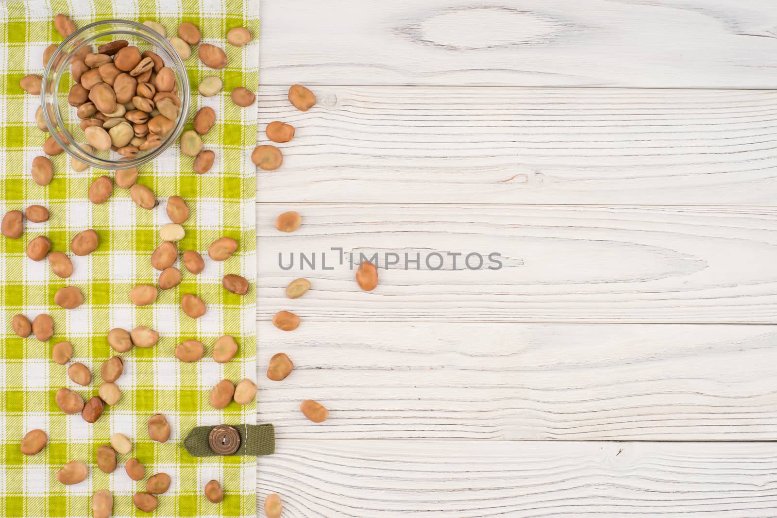 Beans in a glass bowl with on old wooden table.  by DGolbay
