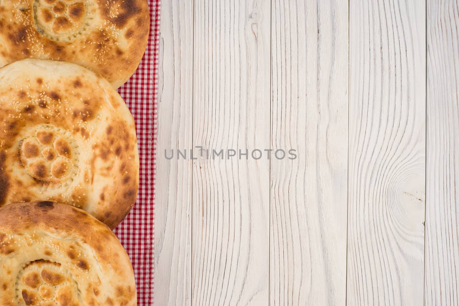 Uzbek bread on old white wooden table.  by DGolbay