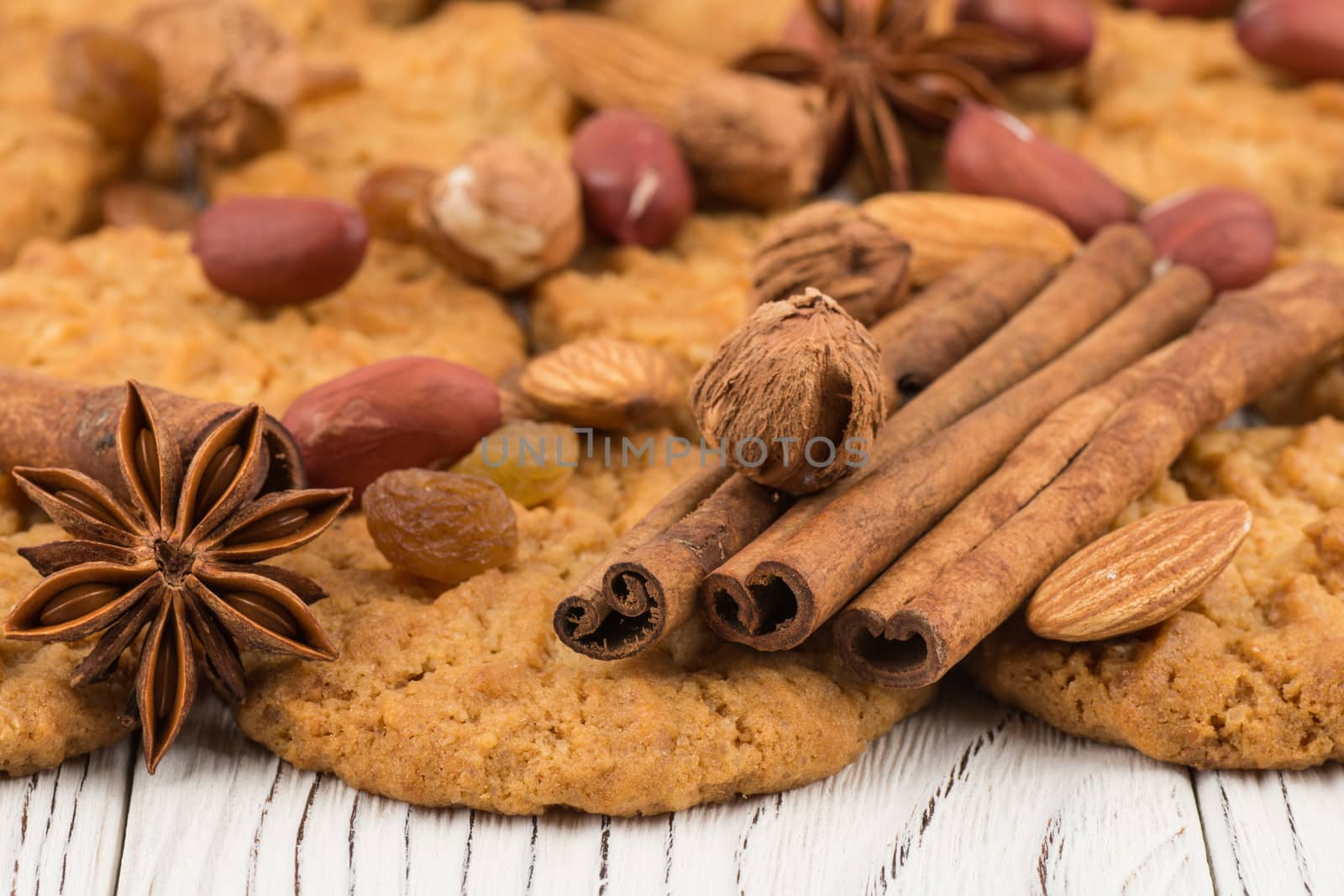 Cookies with almonds and raisins on the old wooden table. Selective focus.