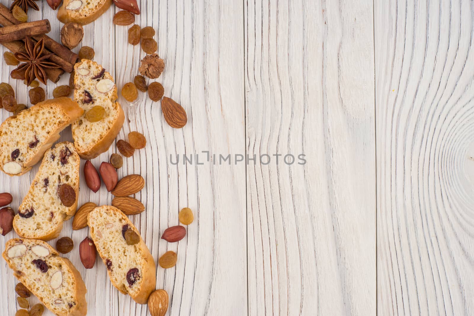 Cookies with almonds and raisins on the old wooden table. Top view.
