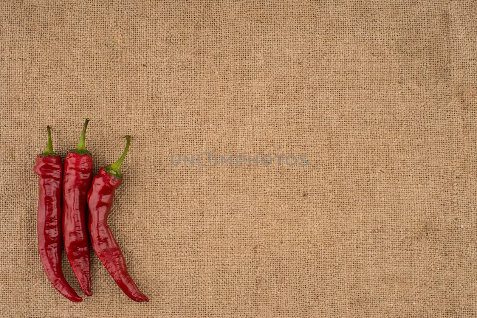 Red chili on burlap. Top view.