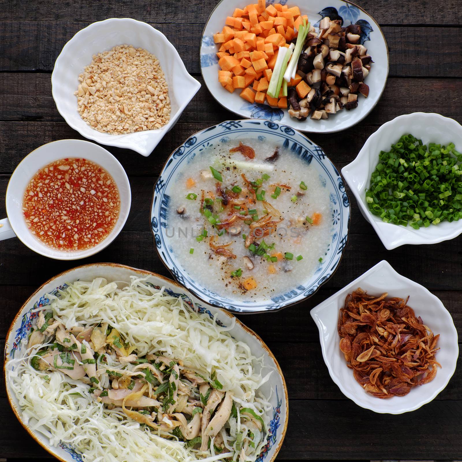 Asian food for sick people, chicken rice gruel with raw material as chicken, rice, carrot, onion, agaric, cabbage. Bowl of chicken porridge with fixed vegetable, also call chao ga