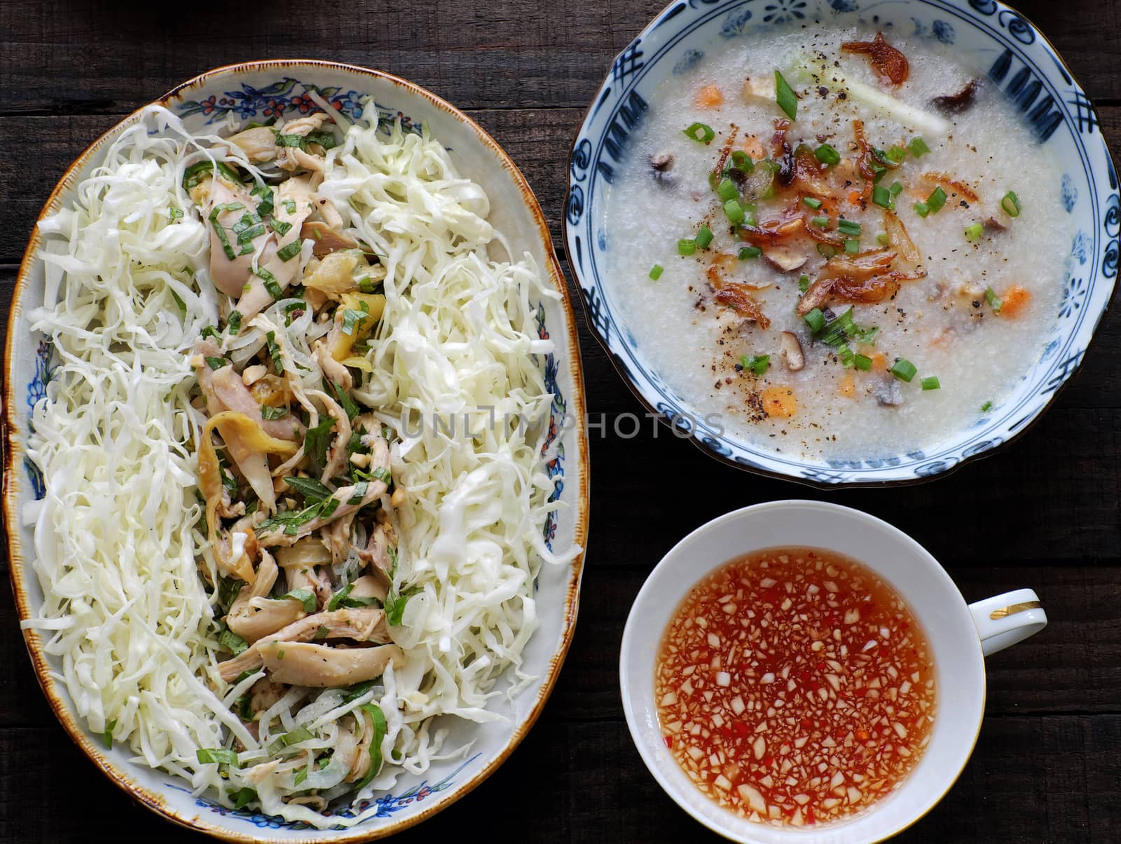 Asian food for sick people, chicken rice gruel with raw material as chicken, rice, carrot, onion, agaric, cabbage. Bowl of chicken porridge with fixed vegetable, also call chao ga