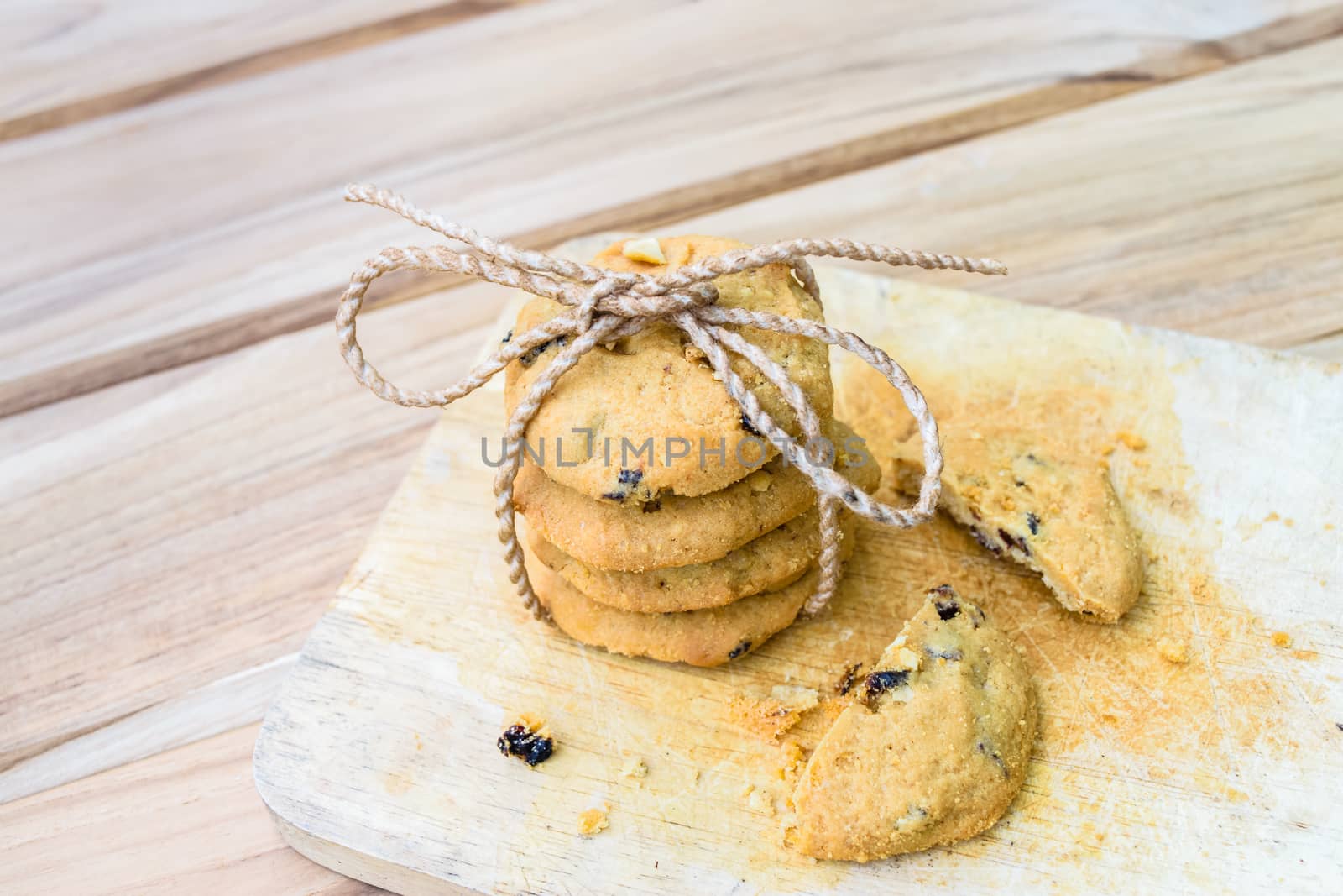 Tasty cookies with chocolate chops against wooden table