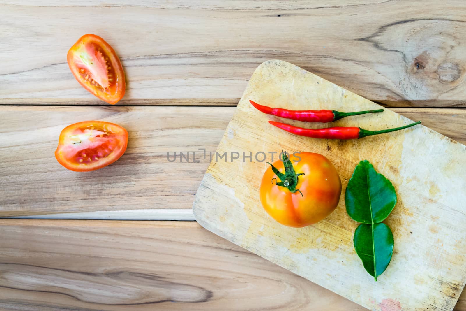 Tomatoes on chopping board with wooden