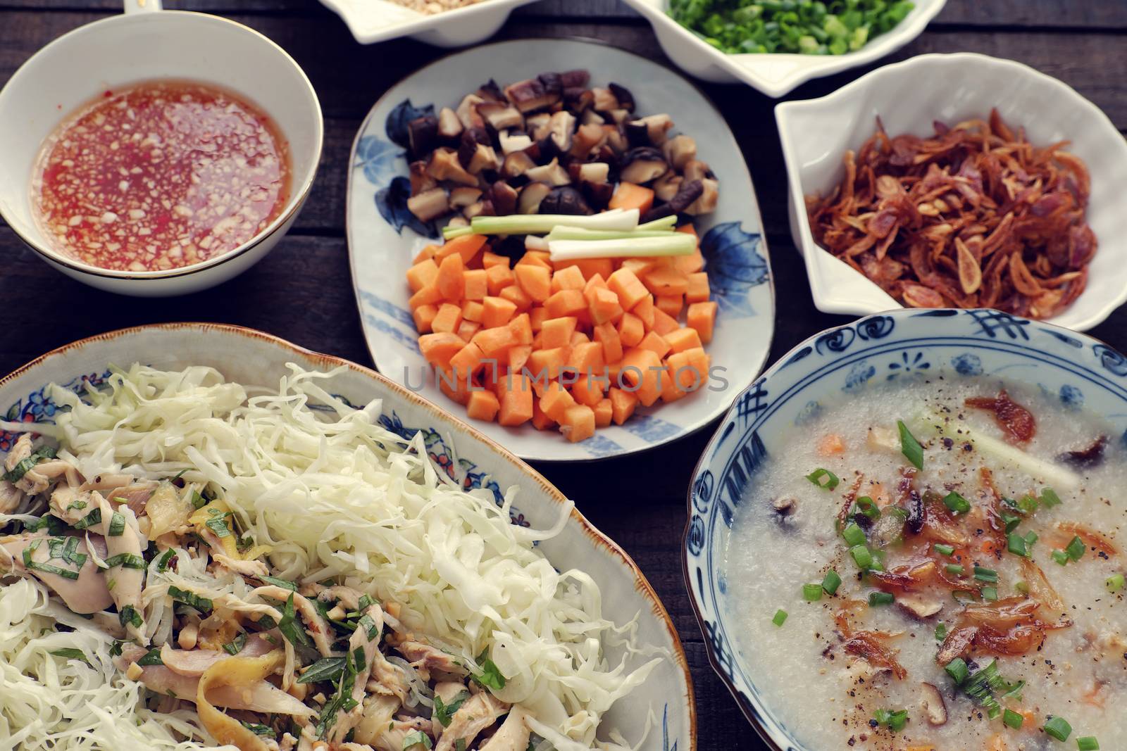 Asian food for sick people, chicken rice gruel with raw material as chicken, rice, carrot, onion, agaric, cabbage. Bowl of chicken porridge with fixed vegetable, also call chao ga