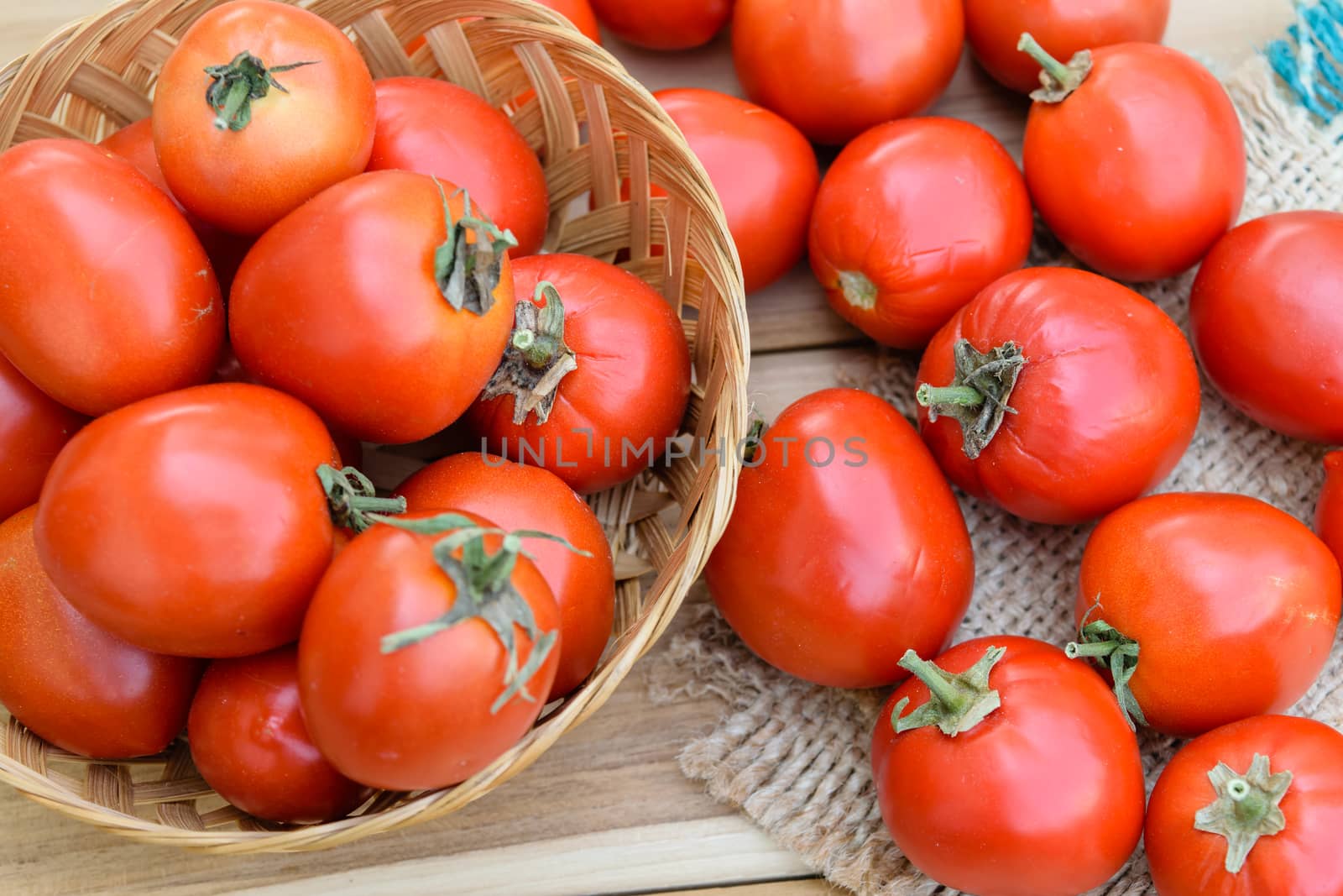 raw tomatoes on wooden table