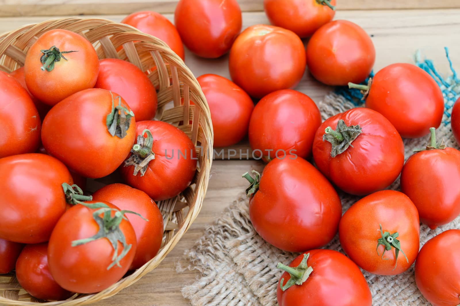 raw tomatoes on wooden table