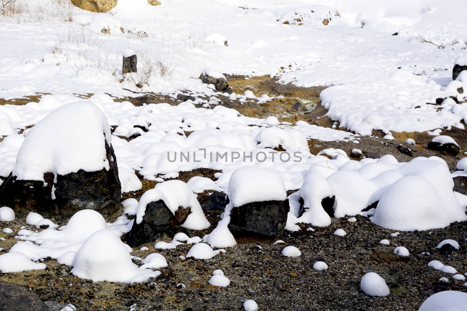 Closeup stone and snow in the mist Noboribetsu onsen snow winter national park in Jigokudani, Hokkaido, Japan