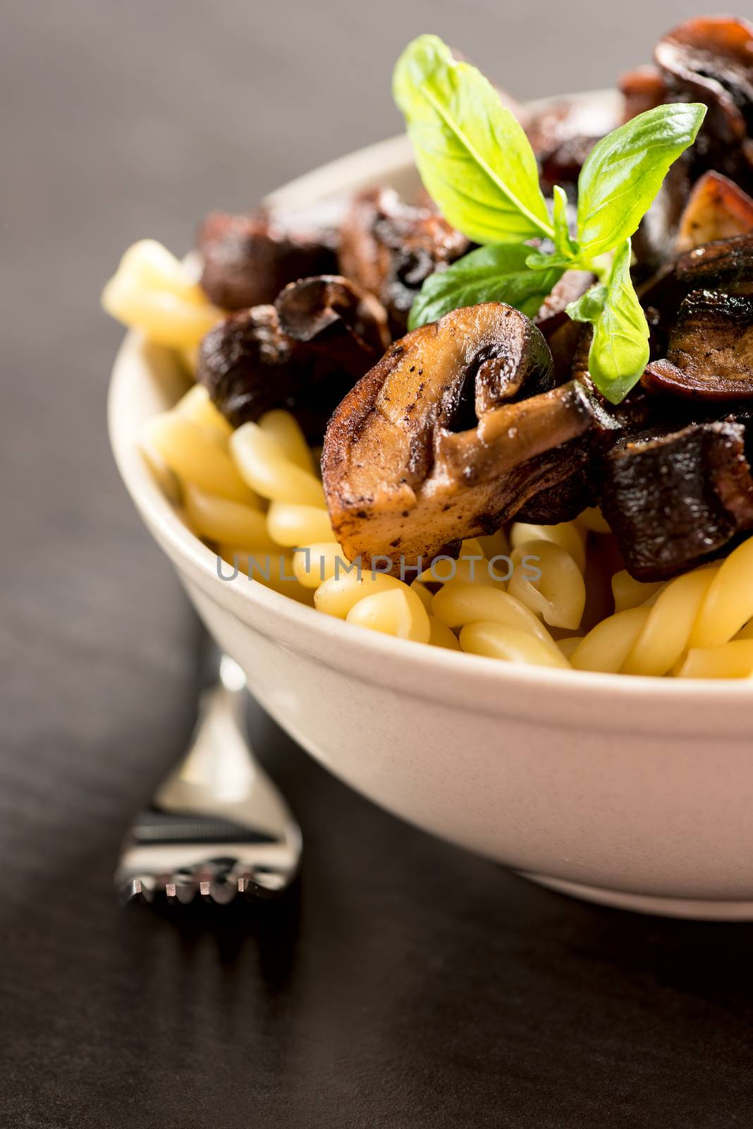 Fusilli with mushrooms, italian cuisine