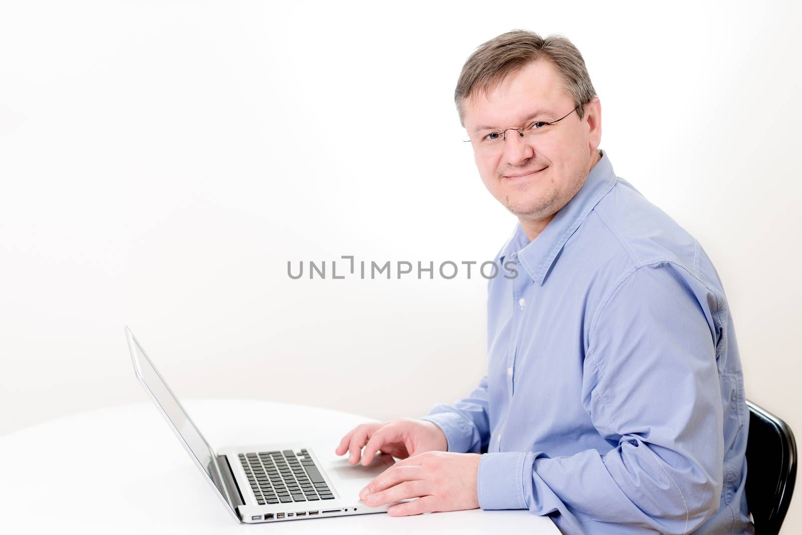 Smiling men working on laptop