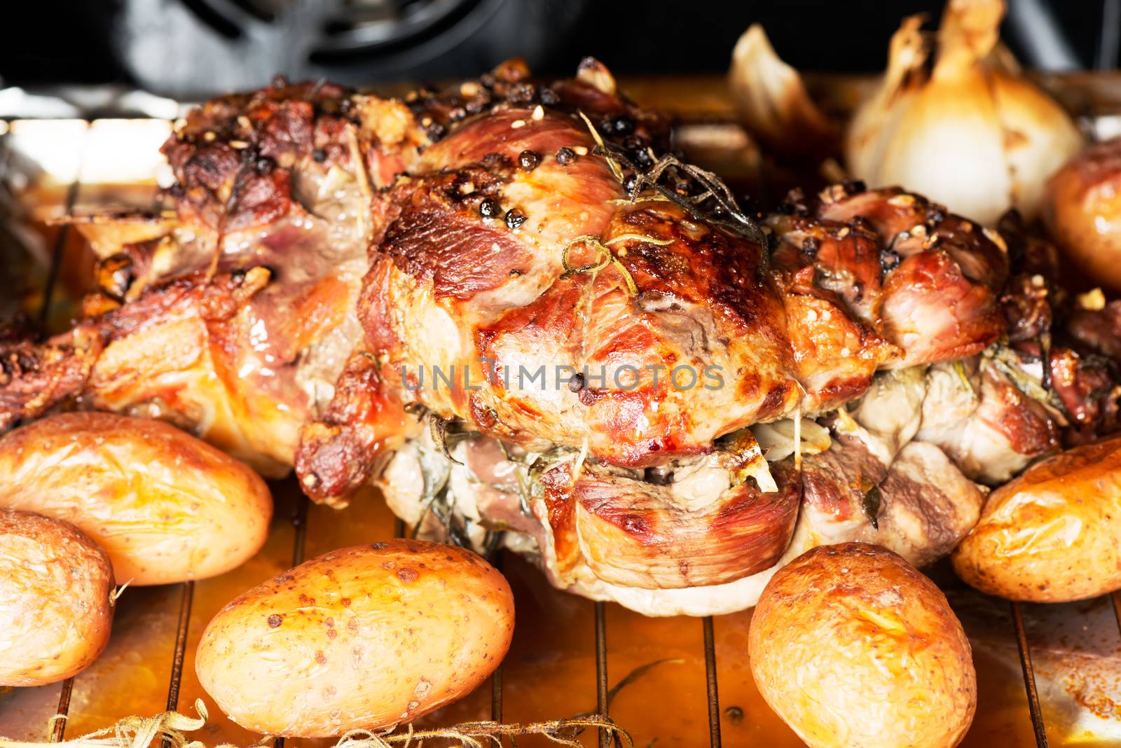 Homemade dish lamb cooking in oven with potatoes