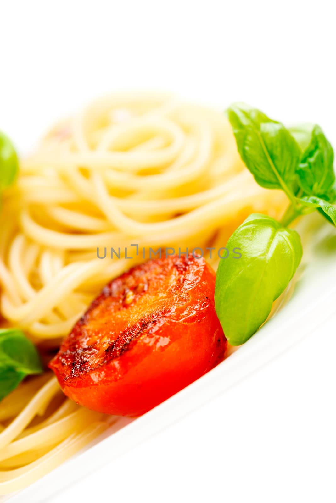 Traditional italian macaroni pasta with grilled tomato and oregano