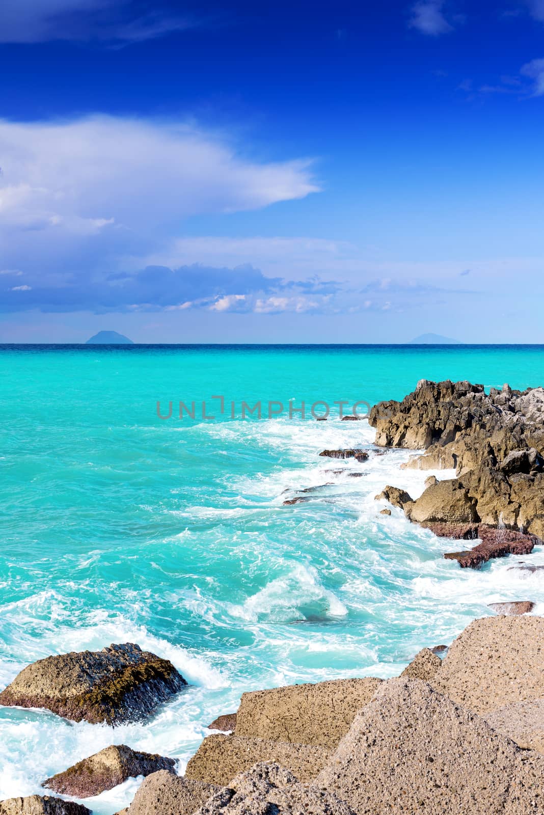 Rocky coast of Sicily with islands far away