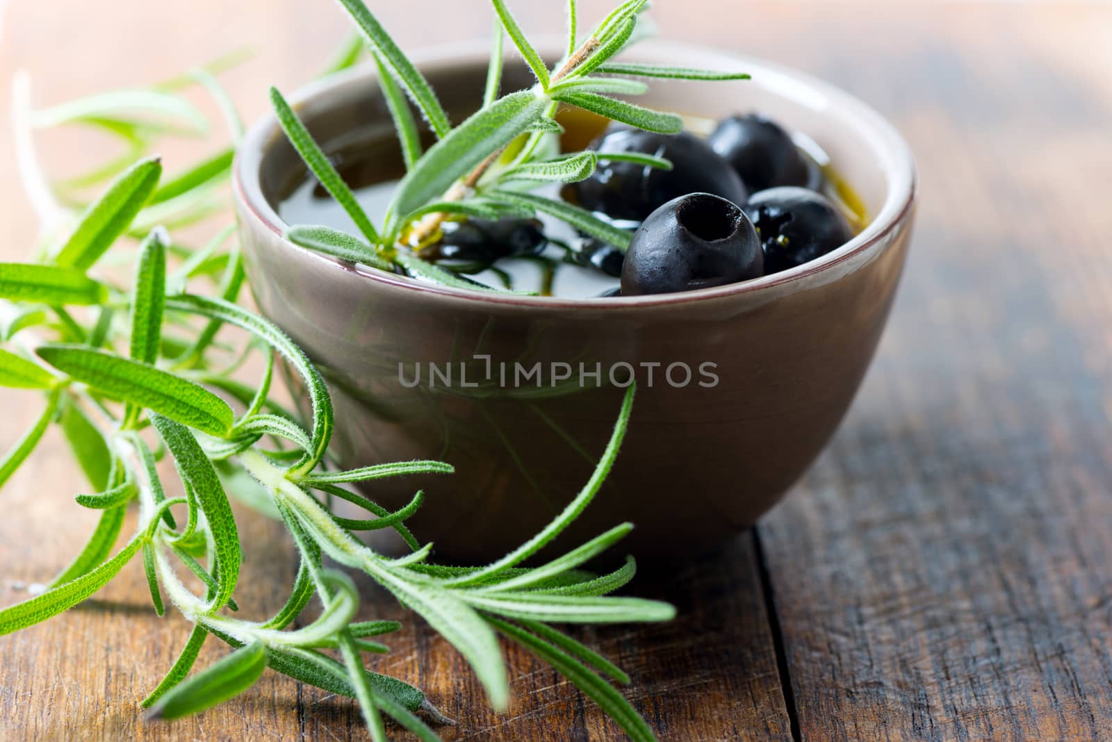 Black olives in bowl by Nanisimova