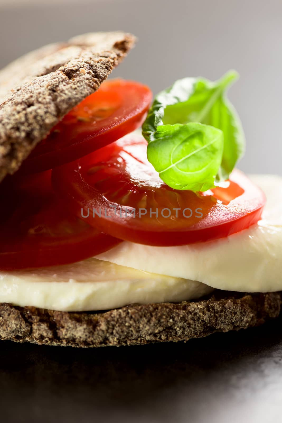 Sandwich with mozzarella tomatoes and rye bread by Nanisimova