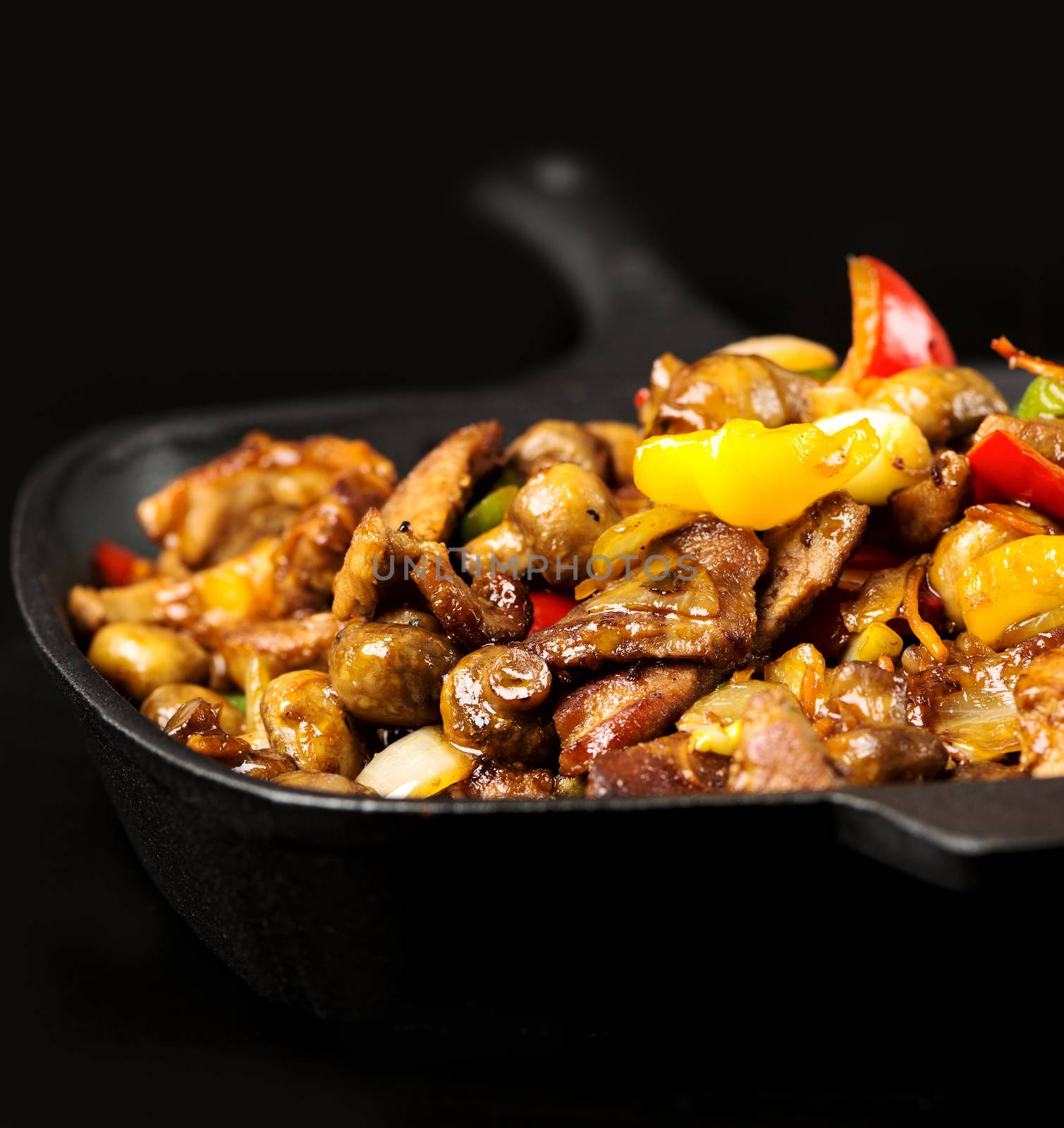 Iron cast skillet with meat and vegetables