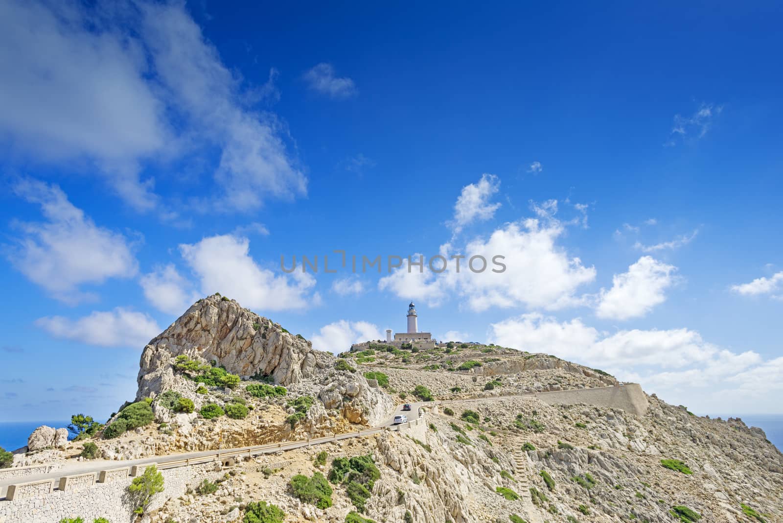 Famous Cap de Formentor, cliff on the northern part of Mallorca island, Spain. Big rocky mountains with lighthous in distance. Tourist destination.