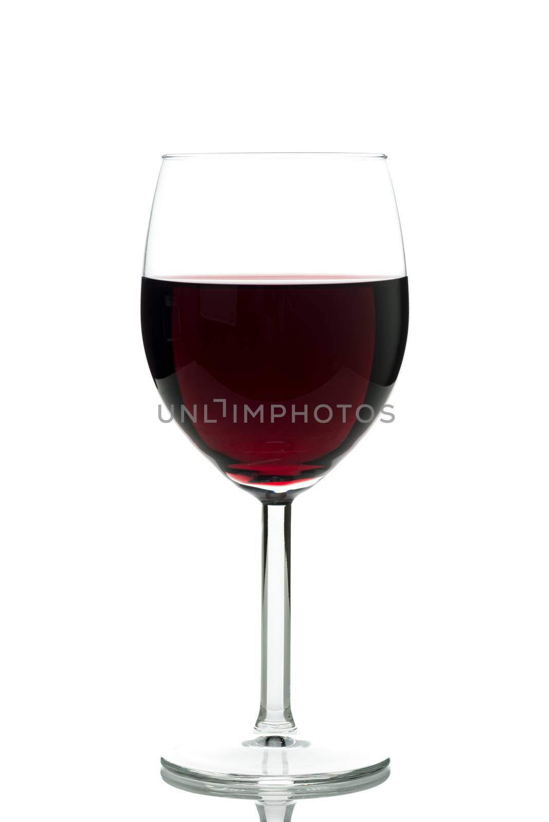 Red wine in a glass isolated by Nanisimova