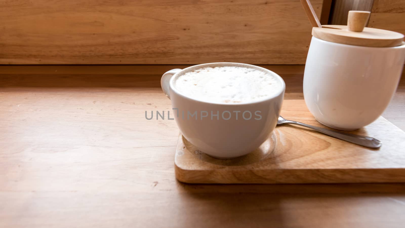 Hot art Latte Coffee in a cup on wooden table and Coffee shop. by dfrsce