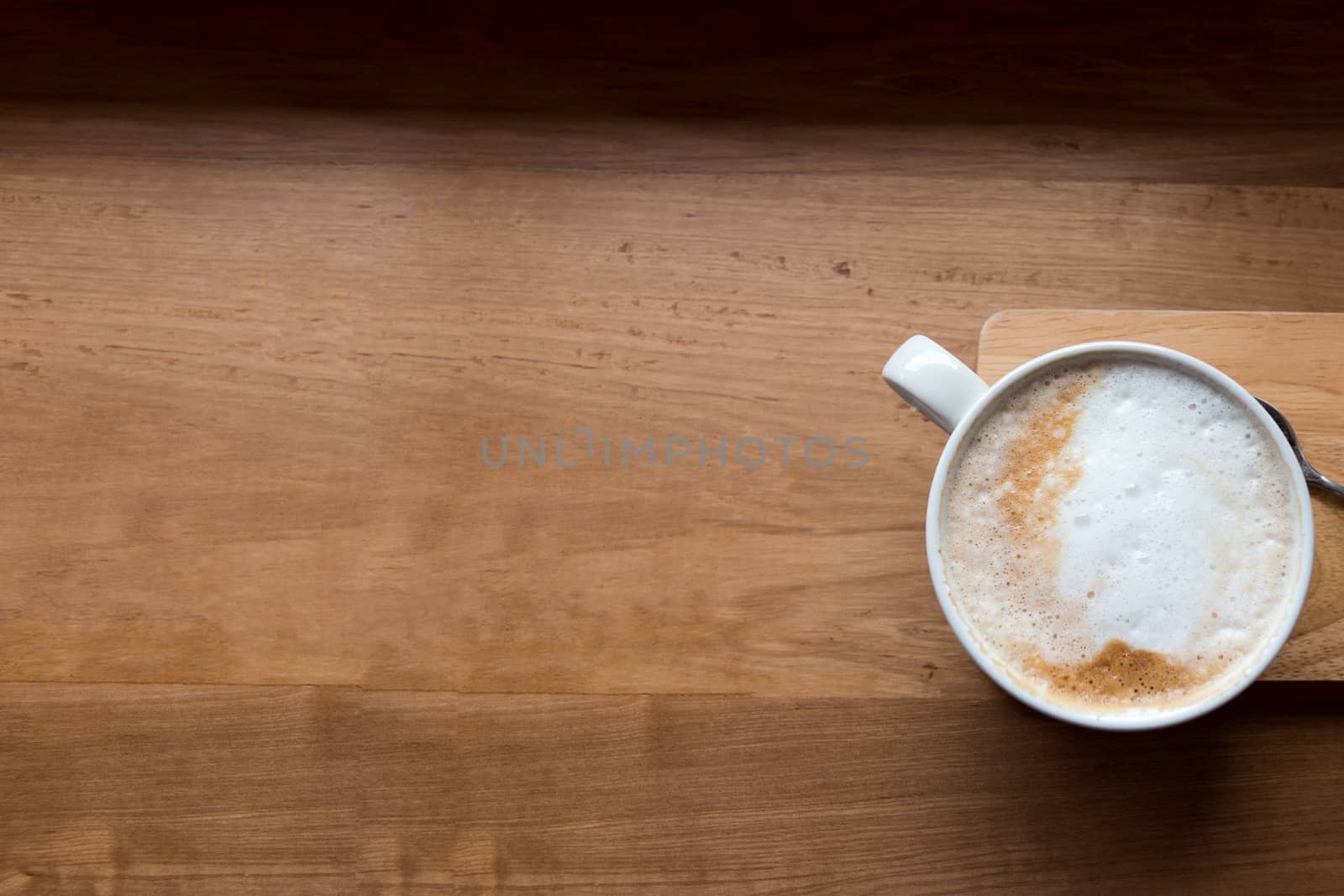 Coffee cup top view on wooden table background.