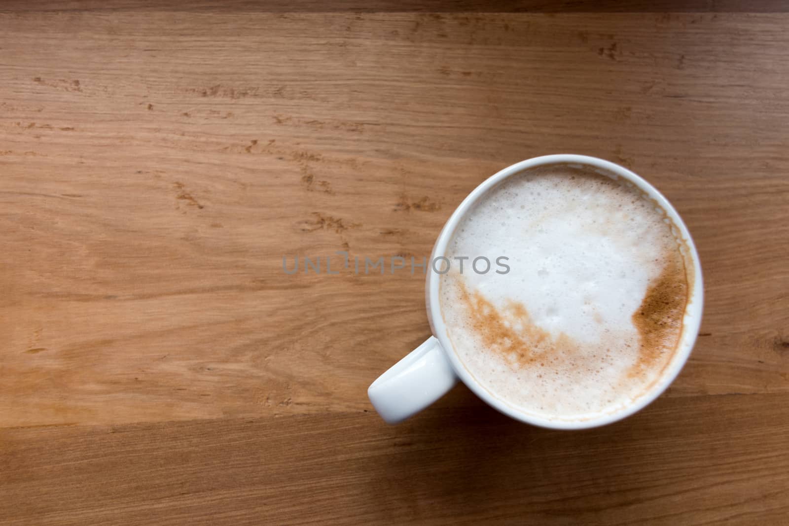 Coffee cup top view on wooden table background.