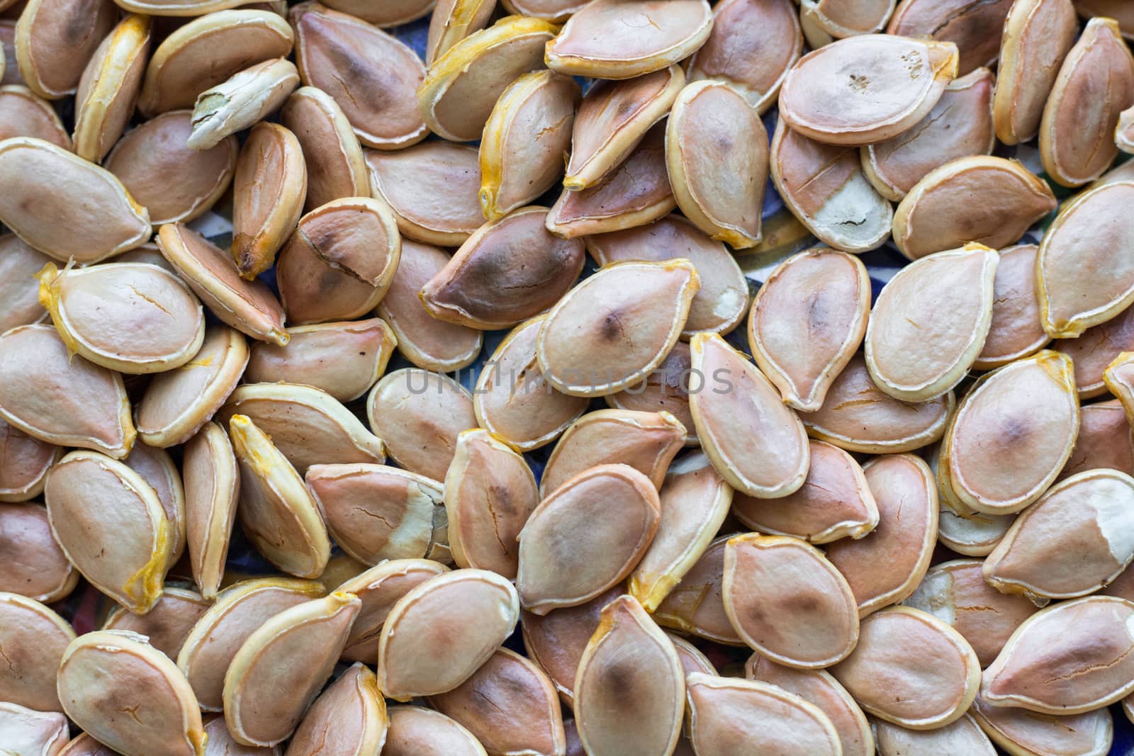 Close-up food background of dry fried yellow white pumkin seeds nuts