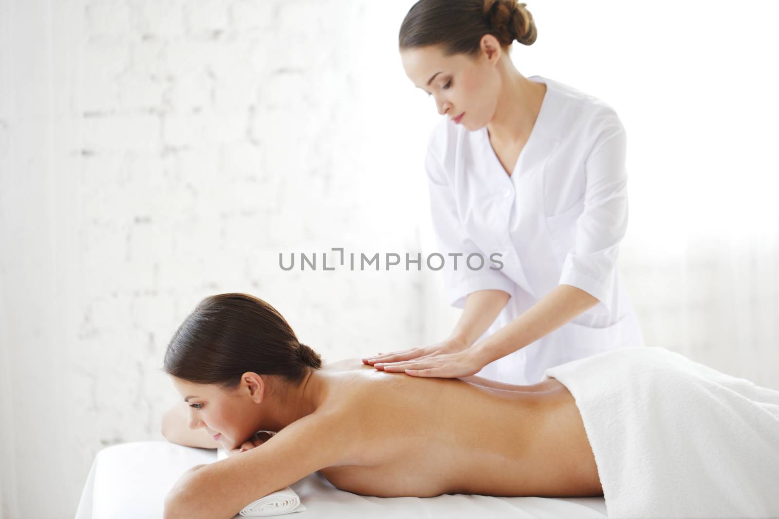 Woman getting massage by ALotOfPeople