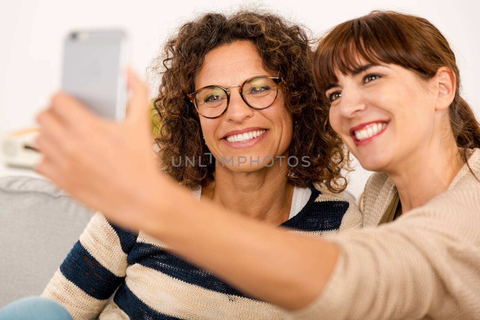 Two beautiful firends at home making  a selfie