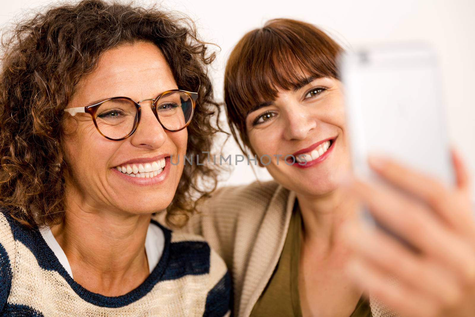 Two beautiful firends at home making  a selfie