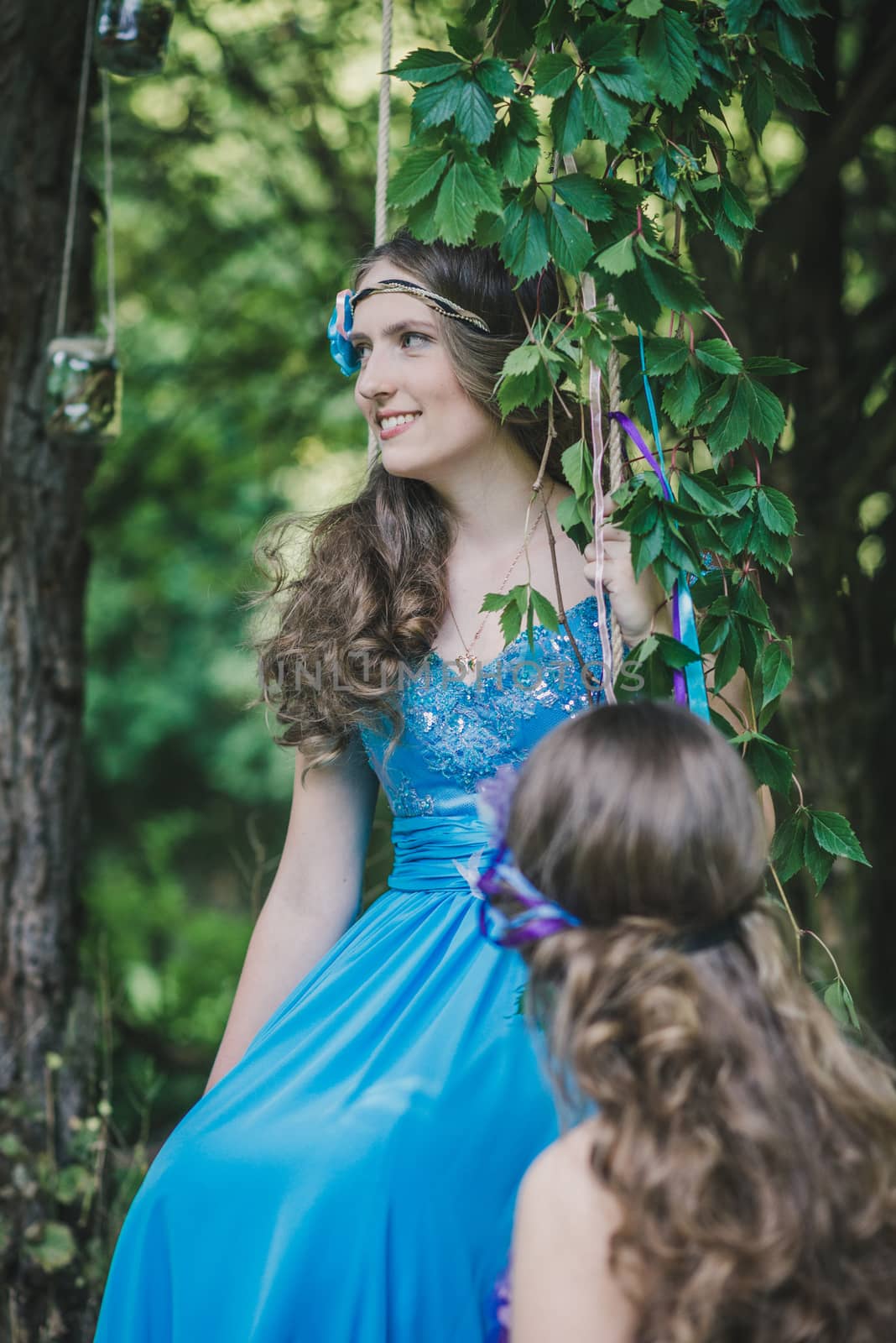 two adult sisters, twins in the summer garden