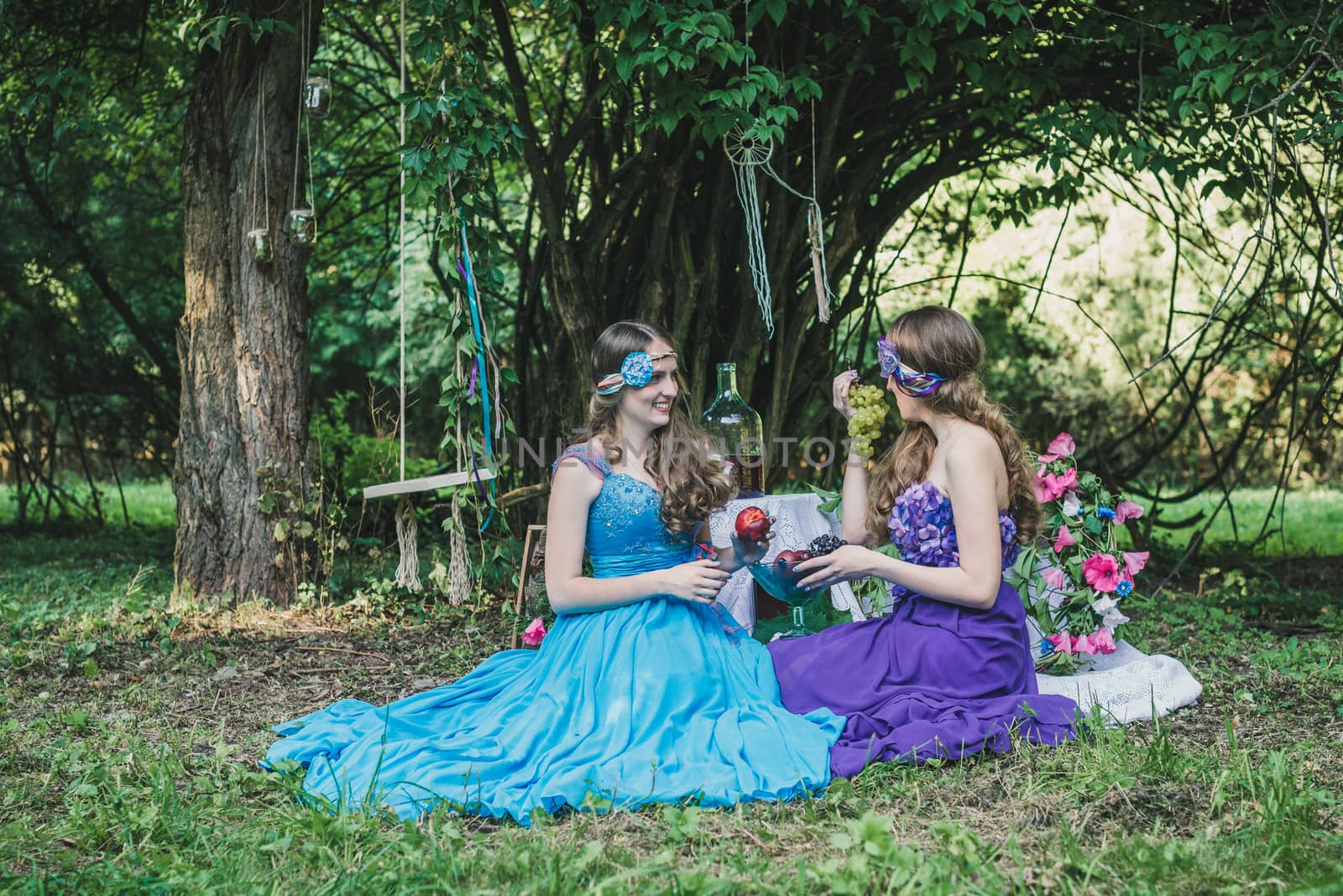 two adult sisters with fruit in the garden