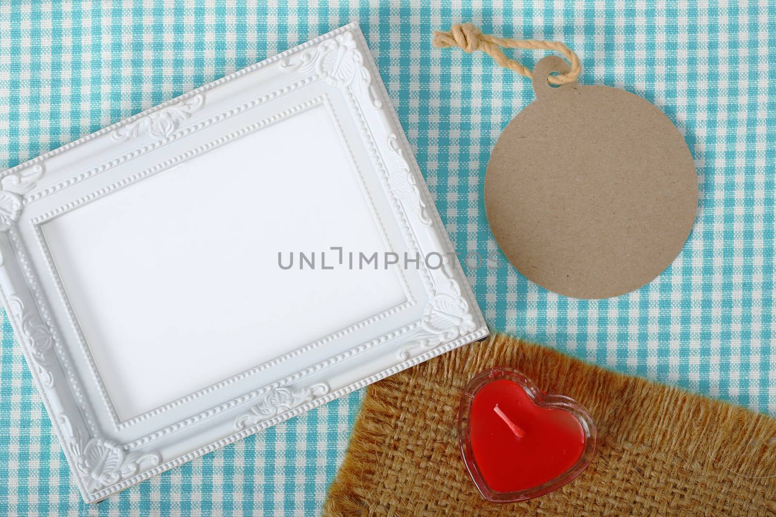 photo frame and paper tag and red heart sign candle in glass ove by phalakon