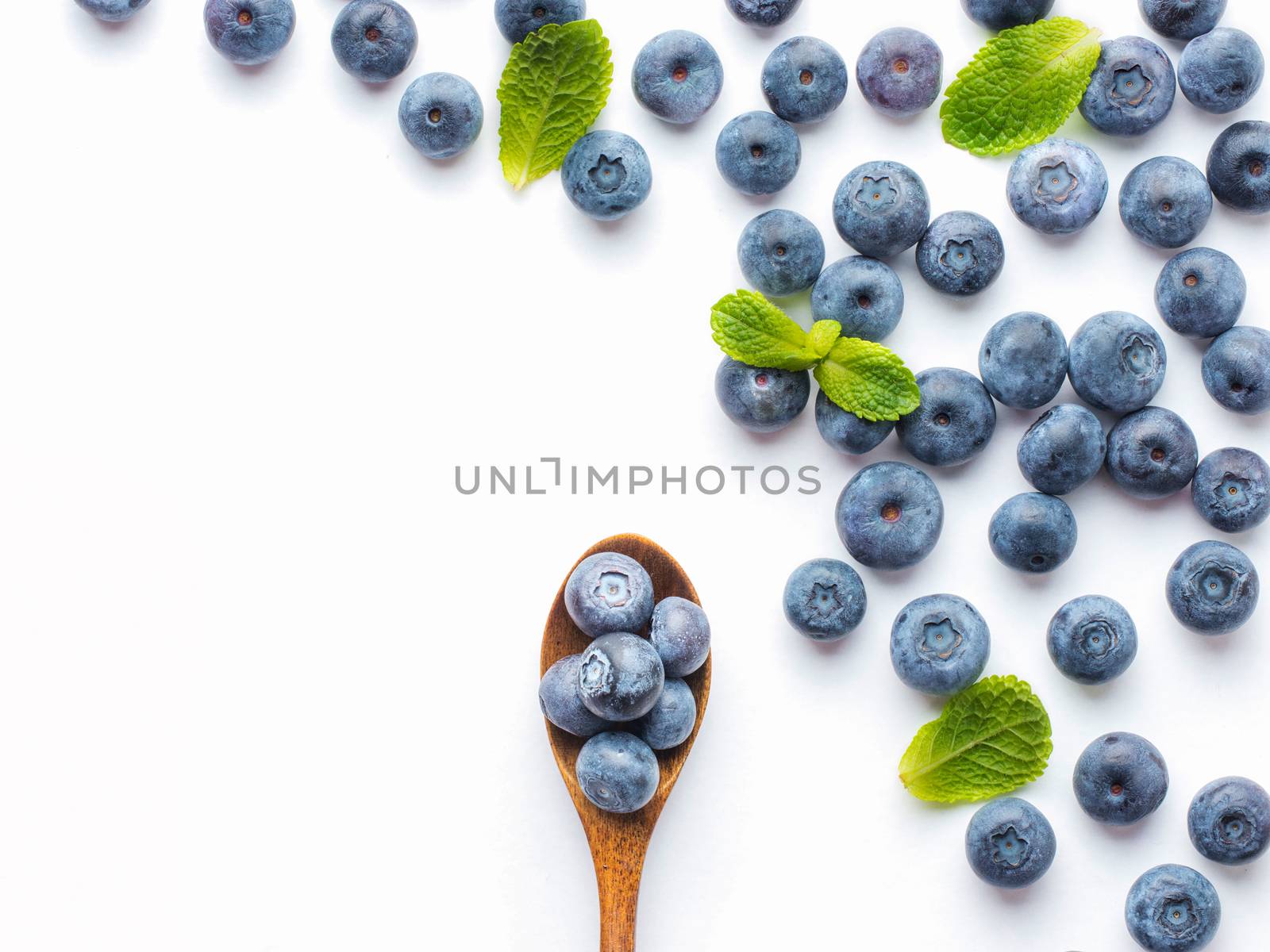 Blueberries isolated on white background. Blueberry border design. Ripe and juicy fresh picked bilberries close up. Copyspace. Top view or flat lay