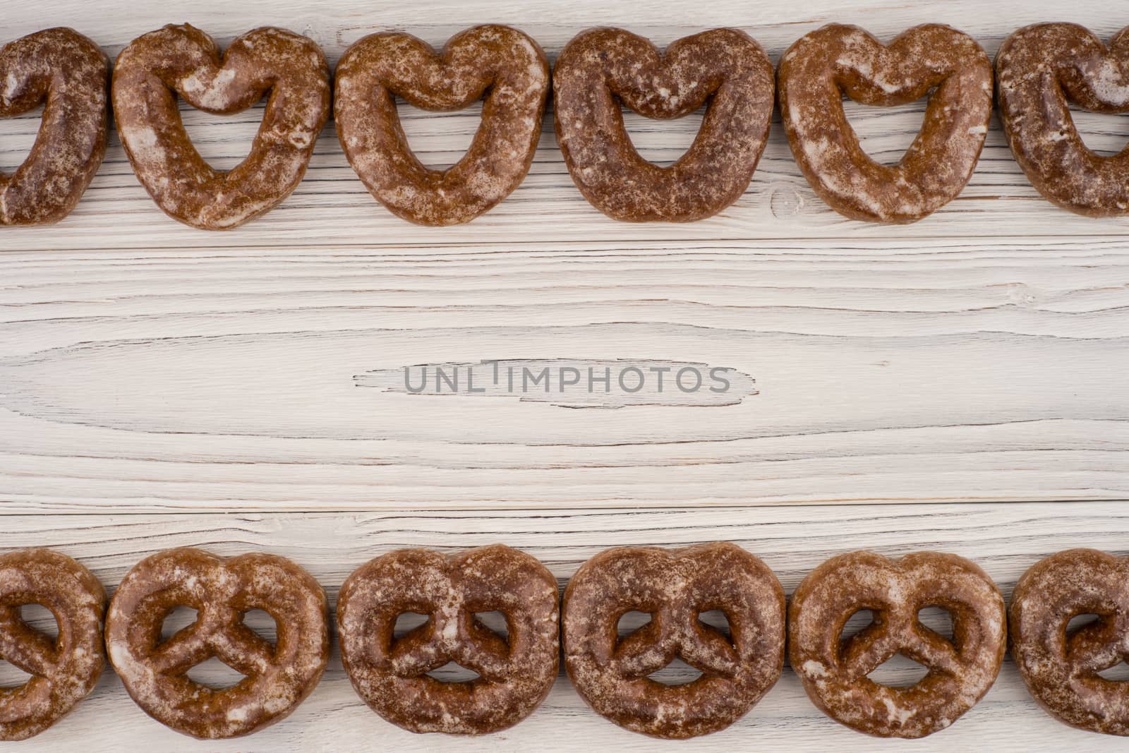 Gingerbread heart cookies on a wooden white background. Top view.